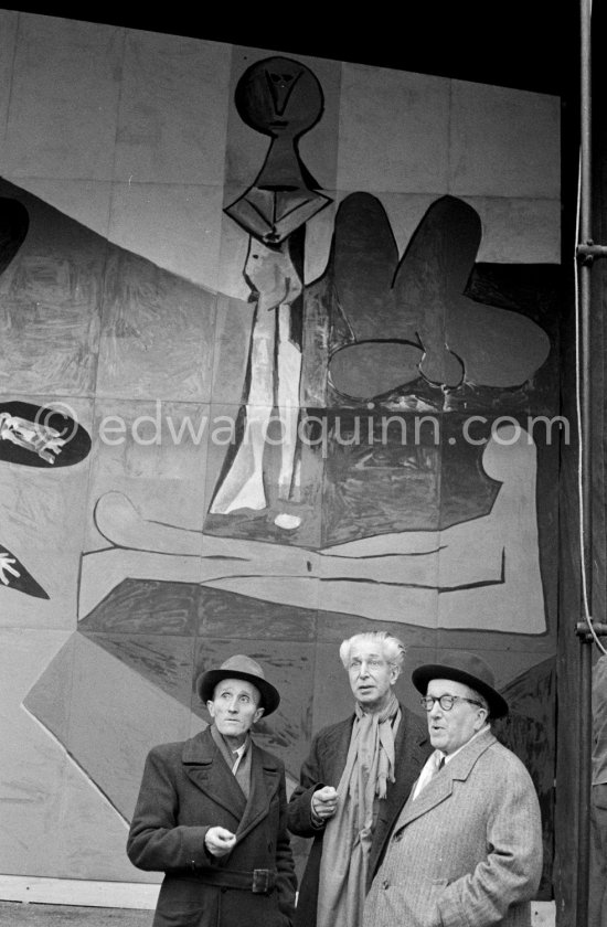 From left Paul Derigon, the mayor of Vallauris, Georges Salles, President of the ICOM (left) and Henri Laugier, Member of the Executive committee of the UNESCO. Unveiling of mural "The Fall of Icarus" ("La chute d\'Icare") for the conference hall of UNESCO building in Paris. The mural is made up of forty wooden panels. Initially titled "The Forces of Life and the Spirit Triumphing over Evil", the composition was renamed in 1958 by George Salles, who preferred the current title, "The Fall of Icarus" ("La chute d\'Icare"). Vallauris, 29 March 1958. - Photo by Edward Quinn