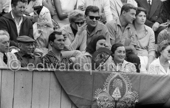 For once Lucia Bosè, wife of Dominguin, can smile at a bunfight, her husband is not in the arena. From left: Jean Cocteau, Pablo Picasso, Luis Miguel Dominguin, Lucia Bosè, Jacqueline. Second row Pablo Picasso’s chauffeur Jeannot, Catherine Hutin. Corrida des vendanges. Arles 1959. - Photo by Edward Quinn