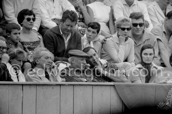 At the bullfight. Dominguin explains some details to Pablo Picasso. From left: Douglas Cooper, Francine Weisweiller, Jean Cocteau, Pablo Picasso, Luis Miguel Dominguin (spectator because of injuries), Lucia Bosè. Second row Pablo Picasso\'s chauffeur Jeannot, Catherine Hutin. Corrida des vendanges. Arles 1959. - Photo by Edward Quinn