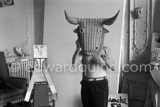 Pablo Picasso with a wicker bull mask originally intended for bullfighters\' training, he becomes a living Minotaur. Beside him is a sculpture made of scrap wood with the features painted on it. La Californie, Cannes 1959. - Photo by Edward Quinn