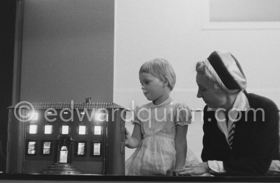 Héléne Ahrenberg playing with the metal model of Pablo Picasso\'s Château de Vauvenargues accompanied by Gallerist Agnes Widlund. Gift of Teto Ahrenberg to Pablo Picasso on the occasion of the visit of the Ahrenberg family to La Californie 1959. - Photo by Edward Quinn