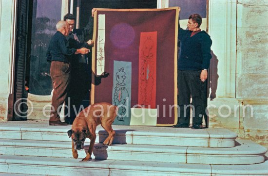 Pablo Picasso discussing with the expert Pierre Baudouin the project for a tapestry designed by him. At right Paulo Picasso. La Californie, Cannes 1959. - Photo by Edward Quinn