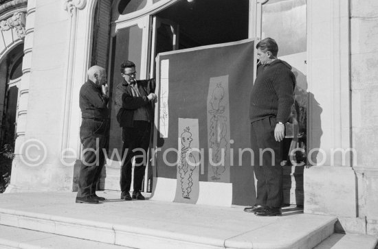 Pablo Picasso discussing with the expert Pierre Baudouin the project for a tapestry designed by him. At right Paulo Picasso. La Californie, Cannes 1959. - Photo by Edward Quinn