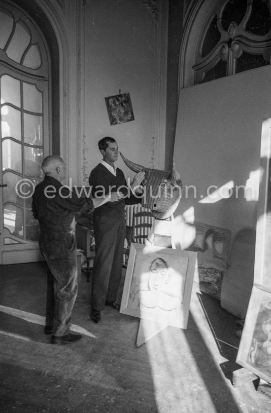 Pablo Picasso with a Spanish wicker mask of a bull, originally intended for bullfighters' training, takes a lesson in bull fighting from an expert, the matador Luis Miguel Dominguin. La Californie, Cannes 1959. - Photo by Edward Quinn