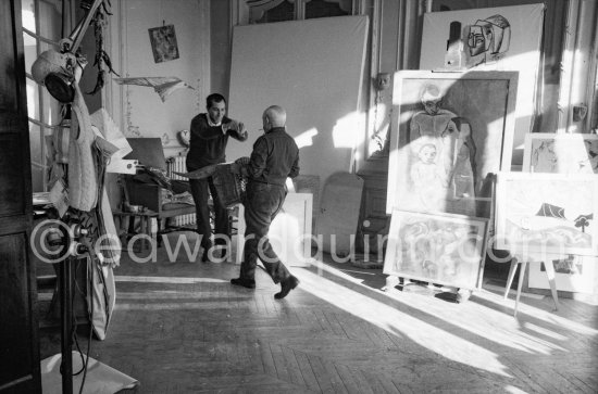 Pablo Picasso with a Spanish wicker mask of a bull, originally intended for bullfighters\' training, takes a lesson in bull fighting from an expert, the matador Luis Miguel Dominguin. La Californie, Cannes 1959. - Photo by Edward Quinn