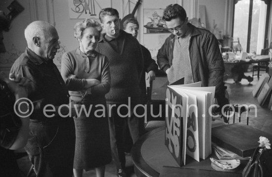 Typical visitors
day at La Californie. Picasso
looks at the first copy of
a deluxe edition of a book
of poems by Pierre Reverdy,
for which he has made the
illustrations. Gathered around
him as he comments on the
book are from left Louise
Leiris, owner 
of the Leiris Gallery Paris, Picasso's son Paulo and the artist Pierre Baudouin. 
La Californie, Cannes 1959. - Photo by Edward Quinn