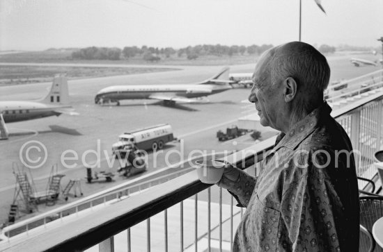 From a terrace at Nice Airport Pablo Picasso watches for the arrival of the Leiris and the Lascaux from Paris. Nice Airport 1960. - Photo by Edward Quinn