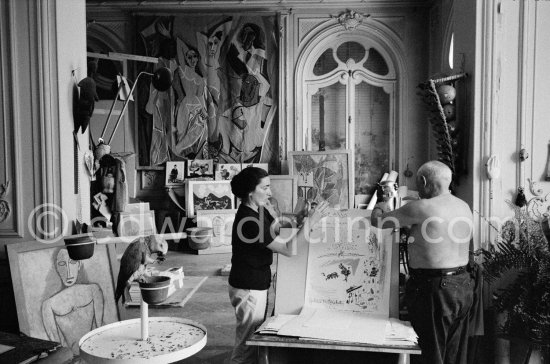 Picasso and Jacqueline showing his original lithograph for the poster announcing his 1960. show in Nice. La Californie, Cannes 1960. - Photo by Edward Quinn