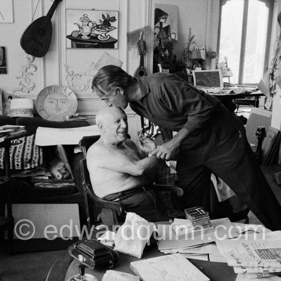 Pablo Picasso and David Douglas Duncan. on the table a pile of english newspapers reporting on Pablo Picasso's London exhibition. La Californie, Cannes 1960. - Photo by Edward Quinn