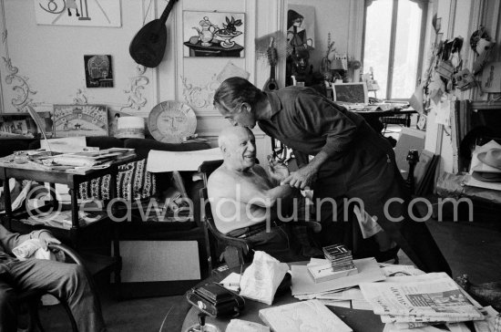 Pablo Picasso and David Douglas Duncan. on the table a pile of english newspapers reporting on Pablo Picasso\'s London exhibition. La Californie, Cannes 1960. - Photo by Edward Quinn