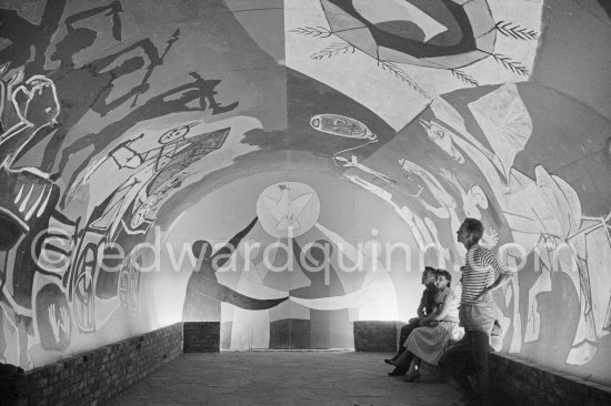 War and Peace ("La Guerre et la Paix") drawing on the vault of the Temple of Peace (Temple de la Paix, or Chapelle de la paix). Pablo Picasso had added a semicircular panel with four interlocked figures holding a dove of peace, suggesting the unity of mankind. Vallauris 1961. - Photo by Edward Quinn