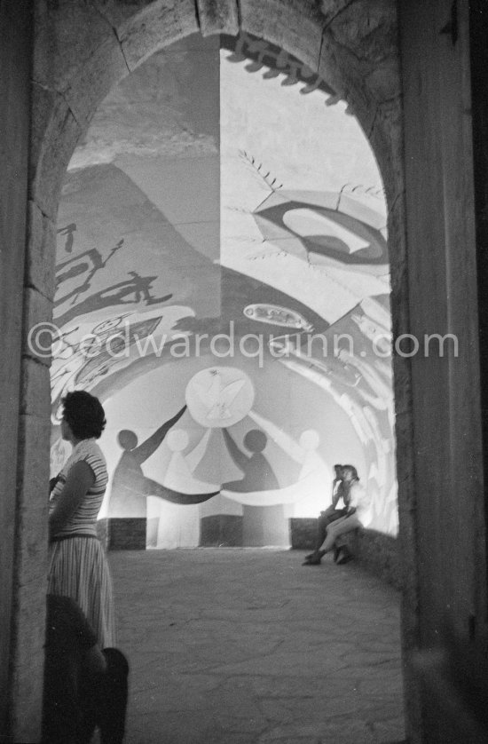 War and Peace ("La Guerre et la Paix") drawing on the vault of the Temple of Peace (Temple de la Paix, or Chapelle de la paix). Pablo Picasso had added a semicircular panel with four interlocked figures holding a dove of peace, suggesting the unity of mankind. Vallauris 1961. - Photo by Edward Quinn