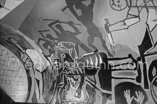 War and Peace ("La Guerre et la Paix") drawing on the vault of the Temple of Peace (Temple de la Paix, alternate Chapelle de la paix). Picasso had added a semicircular panel with four interlocked figures holding a dove of peace, suggesting the unity of mankind. Vallauris 1961. - Photo by Edward Quinn