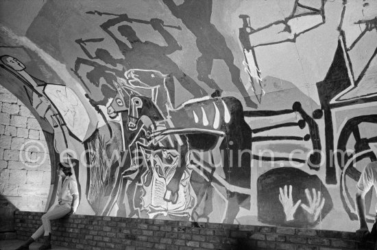 War and Peace ("La Guerre et la Paix") drawing on the vault of the Temple of Peace (Temple de la Paix, alternate Chapelle de la paix). Picasso had added a semicircular panel with four interlocked figures holding a dove of peace, suggesting the unity of mankind. Vallauris 1961. - Photo by Edward Quinn