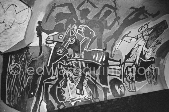 War and Peace ("La Guerre et la Paix") drawing on the vault of the Temple of Peace (Temple de la Paix, or Chapelle de la paix). Far left a dove of peace, superimposed on the face of Françoise Gilot, on a shield of a young man. Vallauris 1961. - Photo by Edward Quinn