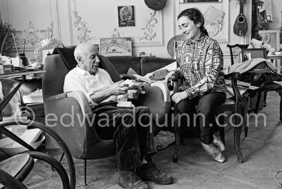 Pablo Picasso and Jacqueline with their Easter presents. Jacqueline is wearing a blouse made from a textile designed by Pablo Picasso. La Californie, Cannes 1961. - Photo by Edward Quinn