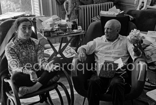 Pablo Picasso and Jacqueline with their Easter presents. Jacqueline is wearing a blouse made from a textile designed by Pablo Picasso. La Californie, Cannes 1961. - Photo by Edward Quinn
