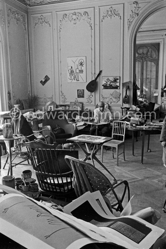 Pablo Picasso working on "Oeuf de pâques" with Caran d'ache wax oil pastels. In the forground a table by Joseph-Marius Tiola. La Californie, Cannes 1961. - Photo by Edward Quinn