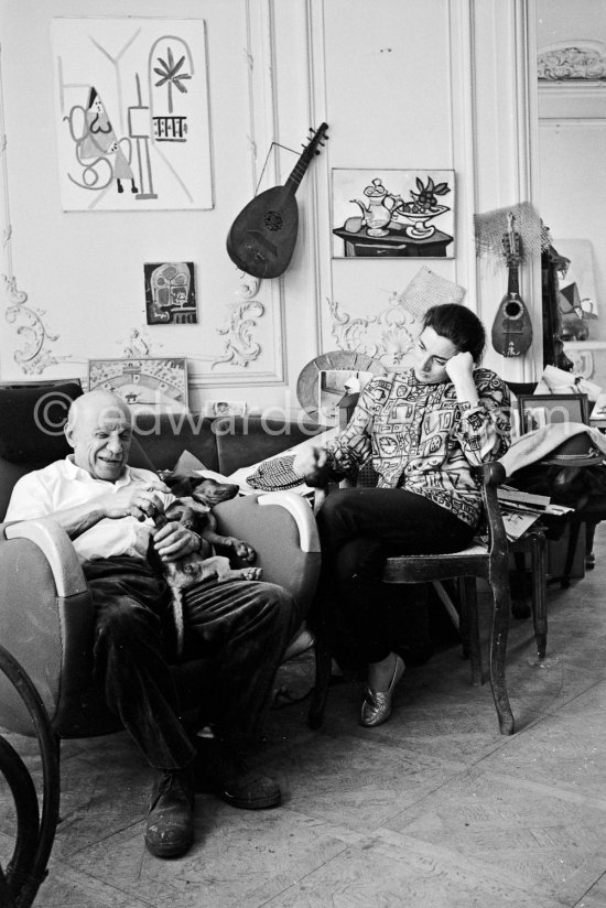 Pablo Picasso and Jacqueline (she is wearing a blouse made from a textile designed by Pablo Picasso) with dachshund Ma Jolie. La Californie, Cannes 1961. - Photo by Edward Quinn
