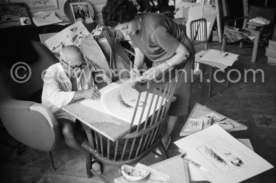 Pablo Picasso signing Rimbaud litho. With Henri Matarasso\'s niece. La Californie, Cannes 1961. - Photo by Edward Quinn