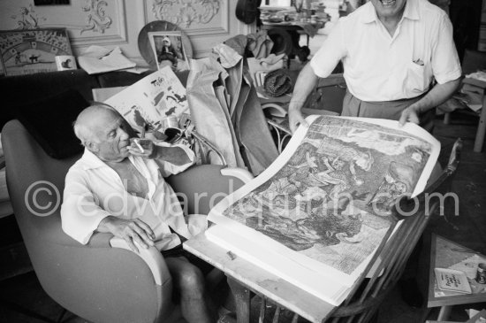 Pablo Picasso and Henri Matarasso, gallery owner and publisher, checking the etching "La Minotauromachie". La Californie, Cannes 1961. - Photo by Edward Quinn