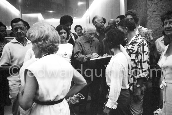 Pablo Picasso signing autgraphs. Marcel Duhamel, Suzanne Ramié, Paloma Picasso, Pablo Picasso, Cathérine "Cathy" Hutin, Paulo Picasso. Galerie Cavalero. Exhibition "Pignon. Gouaches, aquarelles". 4.-25.8.1962. - Photo by Edward Quinn