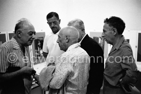 Brassaï, Pablo Picasso, Marcel Duhamel, hidden Jacques Prévert, André Verdet. Opening of exhibition "Images de Jacques Prévert". Château Grimaldi, Antibes, 6.8.1963. - Photo by Edward Quinn