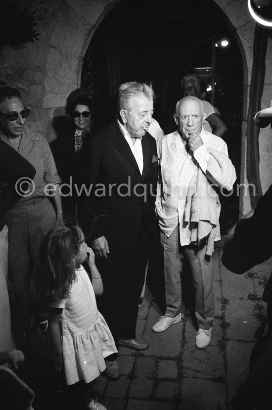 Pablo Picasso and Jacques Prévert. On the left in the background André Verdet and Jacqueline. The girl is Yoyo Maeght, the grandchild of Aimé Maeght. Opening of the exhibition "Images de Jacques Prévert", Château Grimaldi, Antibes, 6.8.1963. - Photo by Edward Quinn