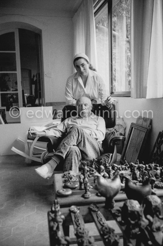 Pablo Picasso and Jacqueline in the room that became known as the viewing room. He would arrange his work so that he could see it from the living room every time he passed. He liked to bring his close friends there for a private viewing. Mas Notre-Dame-de-Vie, Mougins 1964. - Photo by Edward Quinn