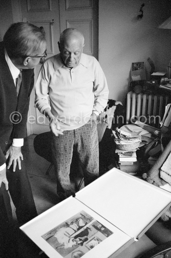 Pablo Picasso and Siegfried Rosengart viewing a portfolio with early works. Mas Notre-Dame-de-Vie, Mougins 1964. - Photo by Edward Quinn