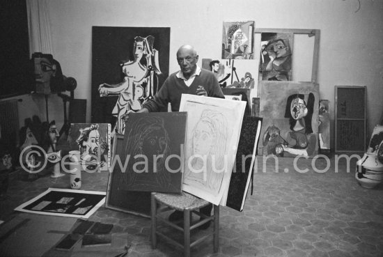 In his studio at Mas Notre-Dame-de-Vie, Pablo Picasso shows for comparison his original linoleum block for "Portrait of Jacqueline" and a linocut print made from it. Mas Notre-Dame-de-Vie, Mougins 1964. - Photo by Edward Quinn