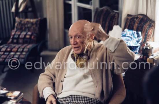 Pablo Picasso and Jacqueline. He rings a little Indian bell which Quinn brought from Ireland. One of the last photos of Pablo Picasso by Edward Quinn. (Scenes in the documentary film "Pablo Picasso l'homme et son oeuvre" by Edward Quinn). Mas Notre-Dame-de-Vie, Mougins 7. Jan 1972. - Photo by Edward Quinn