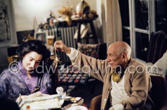 Pablo Picasso and Jacqueline. He rings a little Indian bell which Quinn brought from Ireland. One of the last photos of Pablo Picasso by Edward Quinn. (Scenes in the documentary film "Pablo Picasso l'homme et son oeuvre" by Edward Quinn). Mas Notre-Dame-de-Vie, Mougins 7. Jan 1972. - Photo by Edward Quinn