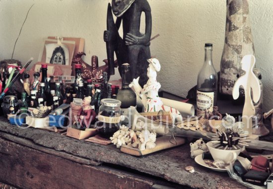 A close-up of the top of a sideboard. Pablo Picasso used every bit of available space to display at clutter of objects, here including an old jam jar labeled "vernis" (varnish). Mas Notre-Dame-de-Vie, Mougins 1974. (Photographed after Pablo Picasso’s death.) - Photo by Edward Quinn