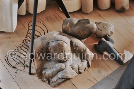 On the floor of the sculpture studio a relief of a sleeping baby contrasts with some grim sculptures. Pablo Picasso reserved the spring bed and some paper clips for eventual views in some of this works. Mas Notre-Dame-de-Vie, Mougins 1974. (Photographed after Pablo Picasso’s death.) - Photo by Edward Quinn