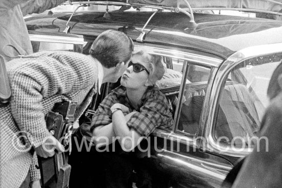 A kiss for the photographer. Edward Quinn and American actress Kim Novak. Cannes Film Festival 1956. Unknown photographer. Car: Cadillac 1954 or 1955 Series 75 Fleetwood sedan or limousine. - Photo by Edward Quinn