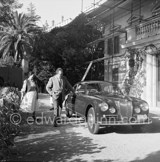 Car enthusiast Prince Rainier of Monaco at his Villa Iberia. He competed under the pseudonym of Louis Carladès at the Tour de France de l\'automobile and crashed into a tree. Saint-Jean-Cap-Ferrat 1954. Car: Lancia Aurelia B20 Gran Turismo 2500 - Photo by Edward Quinn