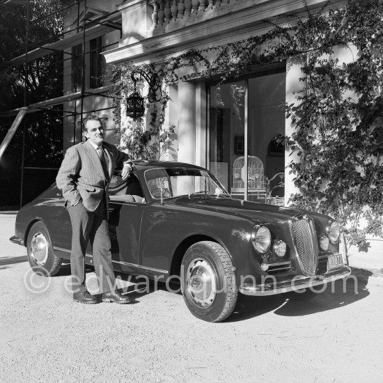 Car enthusiast Prince Rainier of Monaco at his Villa Iberia. He competed under the pseudonym of Louis Carladès at the Tour de France de l\'automobile and crashed into a tree. Saint-Jean-Cap-Ferrat 1954. Car: Lancia Aurelia B20 Gran Turismo 2500 - Photo by Edward Quinn