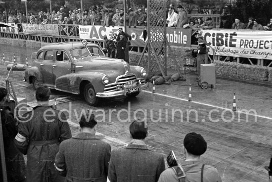 N° 86 Hulsker / Hulsker on Pontiac 25 undergoing the breaking and starting test. Cars will have to accelerate as fast as possible for 200 metres from a standing start, and then pull up in the shortest possible distance, for the cars have to keep a line between the axles. Rallye Monte Carlo 1951. - Photo by Edward Quinn