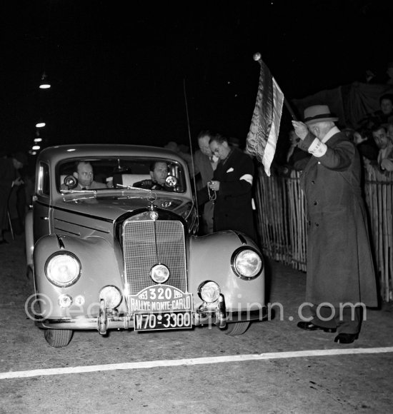 N° 320 Leiner / Nodel on Mercedes 220. Rallye Monte Carlo 1953. To prevent the competitors from taking the timekeepers by surprise and passing without being spotted the organisers decided to paint the front wings of the cars white with washable paint. This enabled the officials to identify hem a long way off even if their rally plates were not easily risible because of dirt or their position on the car. (Louche p. 118) - Photo by Edward Quinn