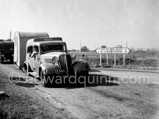 Gypsies on the occasion of the yearly pilgrimage and festival of the Gypsies in honor of Saint Sara, Saintes-Maries-de-la-Mer in 1953. Not identified car. - Photo by Edward Quinn