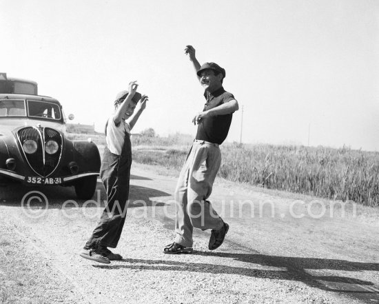 Gypsies on the occasion of the yearly pilgrimage and festival of the Gypsies in honor of Saint Sara, Saintes-Maries-de-la-Mer in 1953. Car: Peugeot - Photo by Edward Quinn