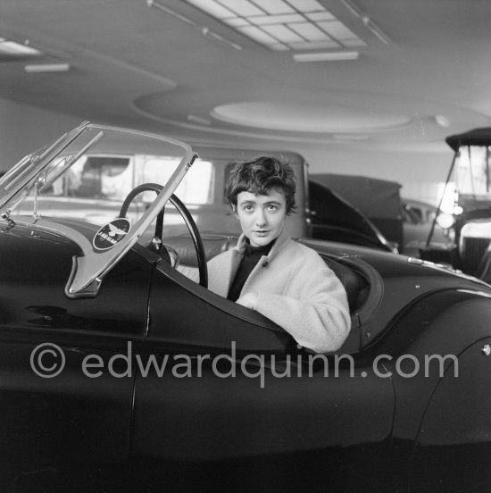 Françoise Sagan evaluating a Jaguar XK120 at the showroom of a Jaguar dealer in Cannes 1954. - Photo by Edward Quinn