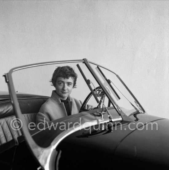 Françoise Sagan evaluating a Jaguar XK120 at the showroom of a Jaguar dealer in Cannes 1954. - Photo by Edward Quinn