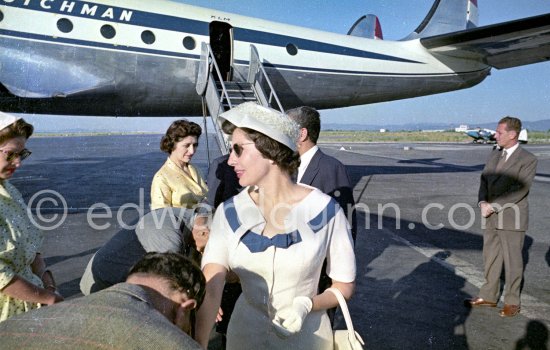 Princess Soraya, behind her, hidden, the Shah. Nice Airport 1957. - Photo by Edward Quinn