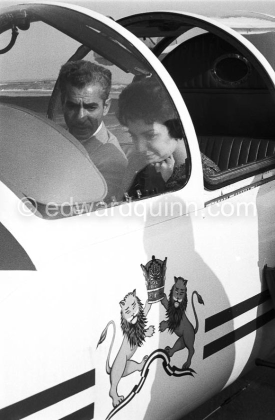 The Shah of Persia and his daughter Princess Shanaz in his plane. Coat of arms of Iran\'s Sovereign. Nice Airport 1958. - Photo by Edward Quinn