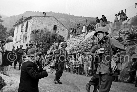 Frank Sinatra on the set of the film "Kings Go Forth" in the village of Tourette-sur-Loup, 1957. Sinatra needed an old lady to partner him in this scene. The villager Marie Isnard, who had never been to the cinema in her life, learned her lines and got through the dialogue very successfully. Sinatra's lines were: "Vive General de Gaulle, Vive les Folies-Bergère", about the only French he knew. - Photo by Edward Quinn