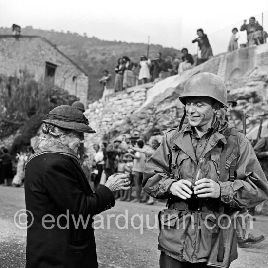 Frank Sinatra on the set of the film Kings Go Forth in the village of Tourette-sur-Loup, 1957. Sinatra needed an old lady to partner him in this scene. The villager Marie Isnard, who had never been to the cinema in her life, learned her lines and got through the dialogue very successfully. Sinatra\'s lines were: \'Vive General de Gaulle, Vive les Folies-Bergere", about the only French he knew. Tourrettes-sur-Loup 1957. - Photo by Edward Quinn