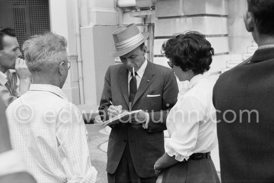 Ol’ Blue Eyes Frank Sinatra signing autographs at the height of his fame; he’d won an Oscar for "From Here to Eternity" and was receiving rave reviews for his album "Come Fly with Me". Monaco 1958. - Photo by Edward Quinn