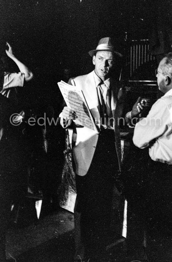 Frank Sinatra rehearsing with the orchestra at the Sporting d’Eté. Princess Grace, who was president of the Monégasque Red Cross, persuaded Sinatra to come back to Europe to sing at a gala in aid of refugee children. Monte Carlo 1958. - Photo by Edward Quinn